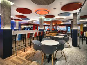a bar with tables and chairs in a restaurant at Sholeo Lodges Los Gigantes in Puerto de Santiago