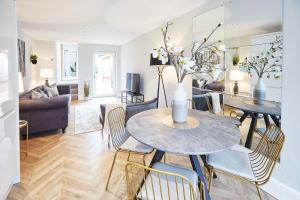 a living room with a table and chairs at The Madison Garden in Whitby