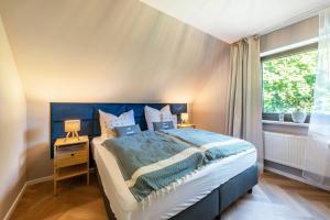 a bedroom with a large bed and a window at Anker in Papendorf