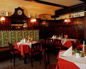 a restaurant with two tables and a clock on the wall at Gasthof Hotel Zweimüller in Grieskirchen