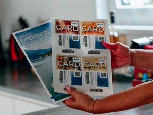 a person is holding a carton of card card at Freiraum Urlaubsapartment in Villach
