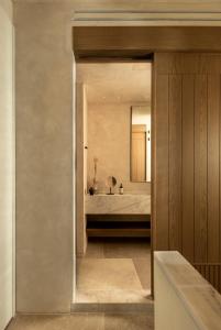 a master bedroom with a bed and a mirror at Meros, Santikos Collection in Naousa