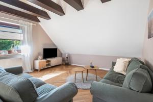 a living room with a couch and a tv at Anker in Papendorf