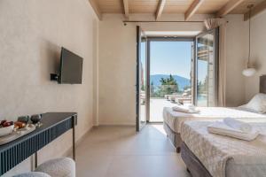 a hotel room with two beds and a balcony at Villa Thalassa by Villa Select in Fiskardo +48 photos
