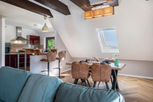 a living room with a blue couch and a table at Anker in Papendorf