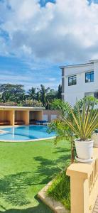 a house with a large yard with a swimming pool at Charming chalet Diani in Diani Beach