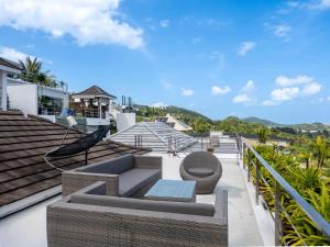 a balcony with a couch and chairs on a roof at Baan Iris 2Br Private Pool & Sunrise Deck in Chaweng