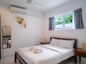 a bedroom with a bed with towels on it at Baan Iris 2Br Private Pool & Sunrise Deck in Chaweng +32 photos