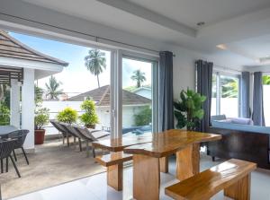 a dining room with a table and chairs at Baan Iris 2Br Private Pool & Sunrise Deck in Chaweng