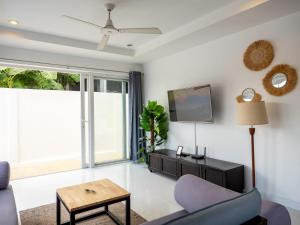 a living room with a couch and a tv at Baan Iris 2Br Private Pool & Sunrise Deck in Chaweng