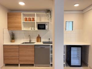 a kitchen with a sink and a microwave at Galilee Nook in Kefar Weradim