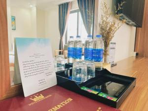 a box of water bottles sitting on a table at White Crown Hotel Ha Long in Ha Long