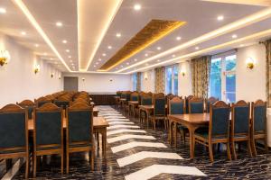 a conference room with wooden tables and chairs at Hotel Town Star in Srinagar