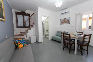 a living room with a table and a dining room at EXCLUSIVE ROOMS Al Vicoletto in Scalea