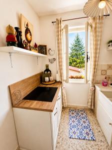 a small kitchen with a sink and a window at La Casetta in San Terenziano