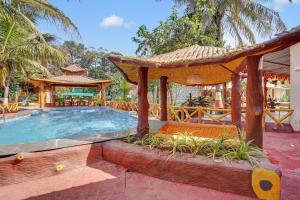 a swimming pool with a gazebo and a resort at Falcon's Retreat in Pune