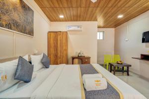 a bedroom with a large bed with a wooden ceiling at Falcon's Retreat in Pune