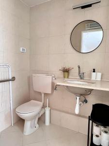 a bathroom with a toilet and a sink and a mirror at Galilee Nook in Kefar Weradim
