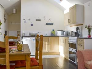 a kitchen with a table and a dining room at Mango Pony's Bothy - Uk31959 in Dibaig