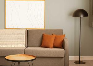 a living room with a couch and a table at Limehome Berlin Chausseestraße in Berlin