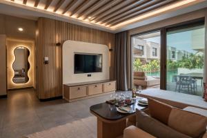 a living room with a television and a couch at Ethno Belek in Belek