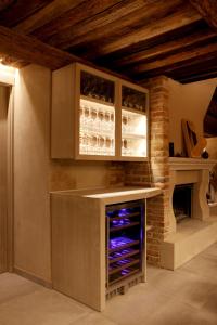 a kitchen with a counter with wine glasses at Cal Miqueló 1778 in Puig-Gros