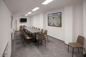 a conference room with a long table and chairs at Hotel PAYER in Teplice
