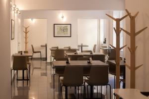 a restaurant dining room with tables and chairs at Hotel PAYER in Teplice