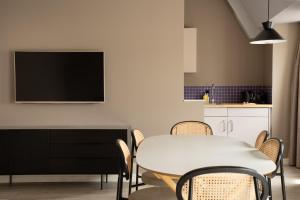 a dining room with a white table and chairs at Limehome Berlin Chausseestraße in Berlin