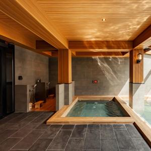 a hot tub in a room with a wooden ceiling at Zen Essence Khao Yai in Khao Yai +147 photos