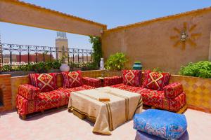 a patio with two couches and a table on a patio at Palais Taroudant in Taroudant