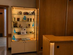 a display case with items in it in a room at Marko Polo Hotel in Aksay +77 photos