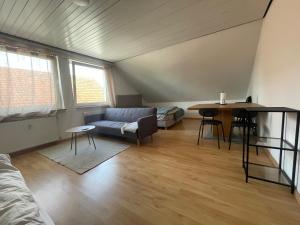 a living room with a couch and a table at Unterkunft in Stadtnähe in Gütersloh