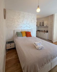 a bedroom with a large bed with colorful pillows at Tiffany apartment - Podgorica in Podgorica