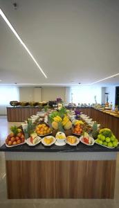 a buffet of fruits and vegetables on a table at Hotel Ararat in Erbil
