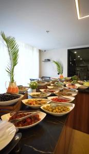 a buffet with many plates of food on a table at Hotel Ararat in Erbil +15 photos