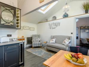 a kitchen with a table with a bowl of fruit on it at The Pavilion in Swaton