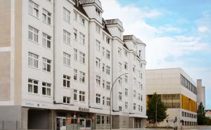 a white building with a street light at Limehome Berlin Chausseestraße in Berlin