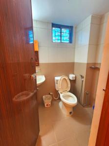 a bathroom with a toilet and a sink at Needs Bay Watch in Cox's Bazar