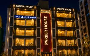 a hotel with a sign in front of a building at Hotel Sun Lorem, Ahmedabad in Ahmedabad