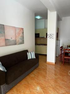 a living room with a couch and a kitchen at Kapo Residence in Vlorë