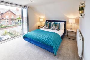 a bedroom with a bed and a large window at The Penthouse Retreat in Whitby