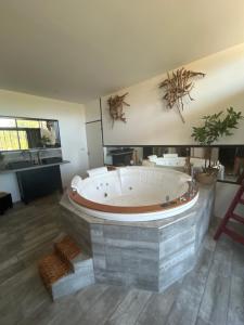 a large bathroom with a large tub in a room at Maison en pierre in Saint-Cyr