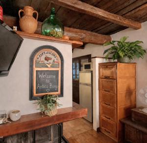 a kitchen with a welcome to arrive book sign on the wall at Antico Borgo in Brugnato