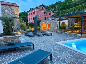 a patio with benches and a swimming pool at Gloria Holiday - Villa di Istria in Piran