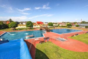 a large pool with a water slide in a park at Pension in Malchin in Malchin