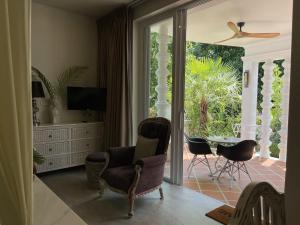 a living room with a sliding glass door to a patio at O - HO Boutique Home in Ban Tai
