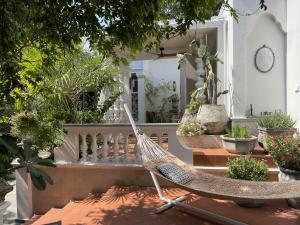 a hammock in the middle of a porch with potted plants at O - HO Boutique Home in Ban Tai