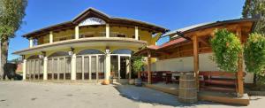 a large building with a table in front of it at Bed and Breakfast Špelca in Pivka