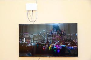 a tv screen with a picture of a city at Comfort Inn Nyeri in Nyeri